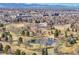 Elevated view featuring a scenic park with a pond, mature trees, and a view of a brick building with a smokestack at 2244 S Franklin St, Denver, CO 80210