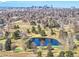 Panoramic aerial view of the neighborhood featuring a tranquil pond surrounded by lush greenery and mature trees at 2244 S Franklin St, Denver, CO 80210