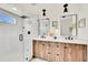 Modern bathroom features dual vanity, wood cabinets, matte black hardware, and glass shower at 2244 S Franklin St, Denver, CO 80210