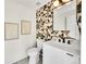 Stylish powder room with modern fixtures, geometric tile accent wall, and floating vanity at 2244 S Franklin St, Denver, CO 80210