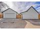 View of the home's garage featuring a large driveway and wooden privacy fence at 2244 S Franklin St, Denver, CO 80210