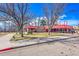 Exterior view of the Harvard Gulch Golf Course facilities with red awnings, surrounded by bare trees at 2244 S Franklin St, Denver, CO 80210