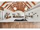 Bright kitchen with wood cabinets, a white countertop island with cooktop, and open layout to the living room at 2244 S Franklin St, Denver, CO 80210