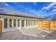 Back of home featuring a patio with stamped concrete, and new windows and privacy fence at 2244 S Franklin St, Denver, CO 80210