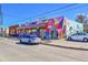 Vibrant exterior showcasing a restaurant with geometric patterns, colorful murals, and ample street parking at 2244 S Franklin St, Denver, CO 80210