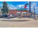 Exterior view of a brick-clad Mexican Grill building featuring outdoor seating and colorful signage under a blue sky at 2244 S Franklin St, Denver, CO 80210