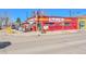 Street view of Stadium Inn with a vibrant red exterior, sidewalk seating, and neighborhood charm at 2244 S Franklin St, Denver, CO 80210