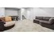 Finished basement area featuring carpeted flooring, a foosball table, and a comfortable sectional sofa at 6018 Beeler Ct, Denver, CO 80238