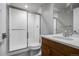 Modern bathroom featuring a glass-enclosed shower and a wood vanity at 6018 Beeler Ct, Denver, CO 80238