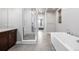 Modern bathroom with a glass-enclosed shower and a separate soaking tub at 6018 Beeler Ct, Denver, CO 80238
