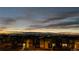 Stunning exterior view of modern homes during sunset, showcasing the neighborhood's charm and community atmosphere with lights on at 6018 Beeler Ct, Denver, CO 80238