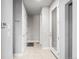 Bright hallway with white doors and tile flooring at 6018 Beeler Ct, Denver, CO 80238
