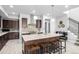 Stylish kitchen island with seating, stainless steel hood, and modern backsplash at 6018 Beeler Ct, Denver, CO 80238