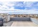 Enjoy city and mountain views from this spacious roof deck with stainless steel grill and plank flooring at 6018 Beeler Ct, Denver, CO 80238