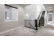 Carpeted staircase with modern black metal railing and natural light at 6018 Beeler Ct, Denver, CO 80238