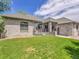 Spacious backyard with lush green lawn, stone facade, and an inviting deck at 4704 W Hinsdale Ct, Littleton, CO 80128
