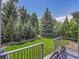 The spacious backyard features well maintained landscaping, a green lawn, and privacy at 4704 W Hinsdale Ct, Littleton, CO 80128