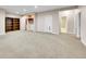 Finished basement with carpet and built-in shelving at 4704 W Hinsdale Ct, Littleton, CO 80128