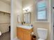 Bright bathroom with a single sink vanity, a toilet, and a shower/tub combination at 4704 W Hinsdale Ct, Littleton, CO 80128