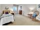 Serene bedroom with a cozy rocking chair, soft carpet, and a full-sized bed at 4704 W Hinsdale Ct, Littleton, CO 80128