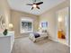 Comfortable bedroom featuring a sunburst mirror, a large window, and a ceiling fan at 4704 W Hinsdale Ct, Littleton, CO 80128