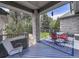 Inviting covered deck features a beautiful blue rug and outdoor seating, perfect for entertaining at 4704 W Hinsdale Ct, Littleton, CO 80128