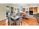 Dining area next to a living room, featuring a large window, a table with seating for six at 4704 W Hinsdale Ct, Littleton, CO 80128