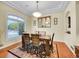 Elegant dining room with a large window, stylish chandelier, and seating for six at 4704 W Hinsdale Ct, Littleton, CO 80128