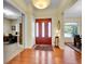 Inviting foyer with hardwood floors, a decorative rug, and an elegant light fixture, setting a warm tone at 4704 W Hinsdale Ct, Littleton, CO 80128