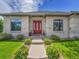 Charming brick home featuring a red front door, manicured landscaping, and classic architectural details at 4704 W Hinsdale Ct, Littleton, CO 80128