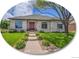 Charming home with a well-manicured lawn, stone facade, and a welcoming red front door at 4704 W Hinsdale Ct, Littleton, CO 80128