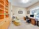 Comfortable home office with built-in shelving, a desk, and a cozy chair at 4704 W Hinsdale Ct, Littleton, CO 80128