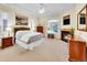 Cozy main bedroom featuring a fireplace, ceiling fan, large window, and ample natural light at 4704 W Hinsdale Ct, Littleton, CO 80128