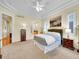 Bright main bedroom with neutral tones, carpeted floors, and a ceiling fan at 4704 W Hinsdale Ct, Littleton, CO 80128