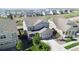 Aerial view of a gray two-story home with well-maintained lawn and mature trees at 15131 Munich Ave, Parker, CO 80134