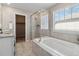Bright bathroom featuring a soaking tub, tiled shower and granite countertop at 15131 Munich Ave, Parker, CO 80134