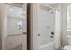 Bright bathroom featuring a shower/tub combo and view into an adjacent room at 15131 Munich Ave, Parker, CO 80134