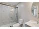 Modern bathroom featuring marble tile shower with sliding glass door and white vanity at 15131 Munich Ave, Parker, CO 80134