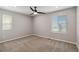 Neutral bedroom with two windows, light colored walls, and a ceiling fan at 15131 Munich Ave, Parker, CO 80134