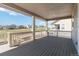 Covered deck overlooking the neighborhood with white railings and ample space for seating at 15131 Munich Ave, Parker, CO 80134