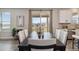 Dining area featuring a modern table, elegant chairs, and an outdoor view through sliding doors at 15131 Munich Ave, Parker, CO 80134