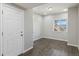 Bright entryway with wood-look flooring, white door, and a window offering views of the neighborhood at 15131 Munich Ave, Parker, CO 80134
