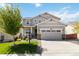 Charming two-story home featuring a covered porch, manicured lawn, and a two-car garage at 15131 Munich Ave, Parker, CO 80134