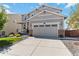 Charming two-story home featuring a covered porch, manicured lawn, and a two-car garage at 15131 Munich Ave, Parker, CO 80134