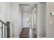 Bright foyer with hardwood floors, white walls, and a view into the living room at 15131 Munich Ave, Parker, CO 80134