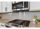 Modern kitchen featuring stainless steel appliances, granite countertops, and white subway tile backsplash at 15131 Munich Ave, Parker, CO 80134