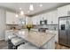 Modern kitchen with stainless steel appliances, white cabinets, and a large granite island at 15131 Munich Ave, Parker, CO 80134