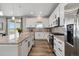 Modern kitchen with stainless steel appliances, white cabinets, and a large granite island at 15131 Munich Ave, Parker, CO 80134