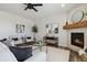 Inviting living room showcasing a stone fireplace, stylish decor, and contemporary furnishings at 15131 Munich Ave, Parker, CO 80134