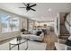 Open-concept living room with hardwood floors, a neutral color scheme, and plenty of natural light at 15131 Munich Ave, Parker, CO 80134